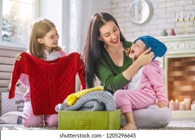 Winter Portrait Of Happy Loving Family Wearing Knitted Sweaters. Mother And Children Girls Having Fun, Playing And Laughing At Home. Fashion Concept.