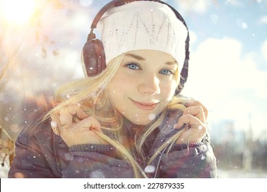 Winter Portrait Of Young Girl With Headphones Music