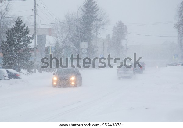 Winter rainy day. Poor\
visibility , snow on the roads . To slow down the speed of the car,\
headlights.