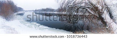 Winter river. A winter river landscape with snow-covered banks.
