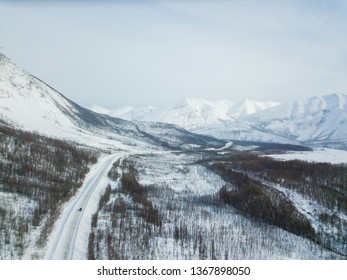 Winter Road Along The Kolyma Highway Among The Mountains In Yakutia