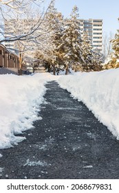 Winter Road, Path With Salt For Melting Snow And House In Background