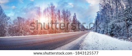 Winter road with snow and the trees all around