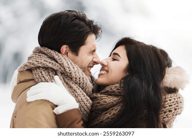 Winter Romance. Cute Lovers Rubbing Their Noses Embracing Standing In Beautiful Snowy Park Having Morning Date Outdoor - Powered by Shutterstock