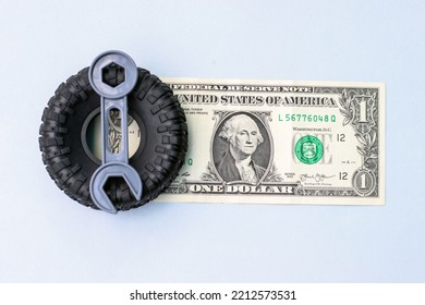 Winter Rubber Black Tire Toy Car Wrench Plastic Key And One Two Dollar Bills Isolated Mockup Free Space For Text.tire Change Replacement Summer Winter Season Auto Service Concept Payment Saving Money