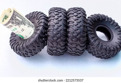 Winter Rubber Black Tire Toy Car Wrench Plastic Key And One Two Dollar Bills Isolated Mockup Free Space For Text.tire Change Replacement Summer Winter Season Auto Service Concept Payment Saving Money