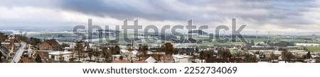 Winter rural landscape with cloudy sky, in the foreground town Schieder-Schwalenberg in the state of North Rhine-Westphalia in Germany