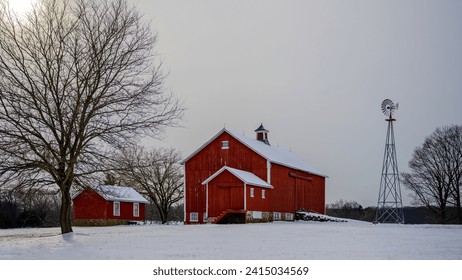 Winter rural road travel landscape in New England of America with bare trees, snow-covered hills, and barns - Powered by Shutterstock