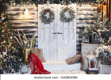 Winter rustic interior decorated for New year with artificial snow and Christmas tree. Winter exterior of a country house with Christmas decorations in rustic style. Christmas eve