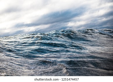 Winter sailing. Cold blue sea at sunset. Waves and clouds, Norway