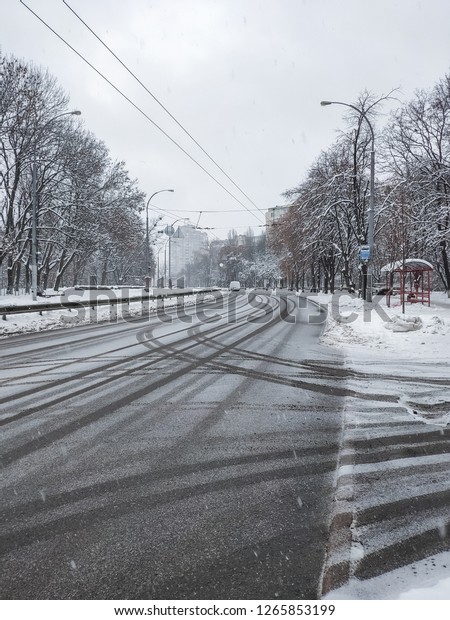 winter scene with\
curved tracks in snow\
city