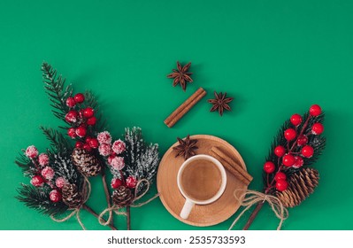 Winter scene made of Christmas tree branches, pinecones, red berries and cup of coffee with cinnamon sticks and star anise on green background. Minimal winter coffee concept. Flat lay. - Powered by Shutterstock