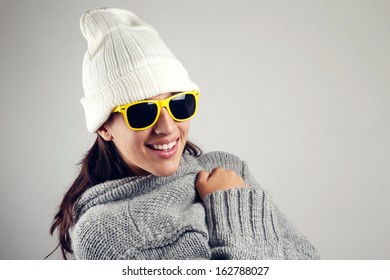 Winter Scene Of Pretty Young Woman With White Wool Cap And Yellow Sunglasses