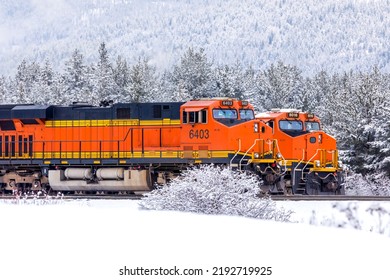 Winter Scene Of Two Locomotives With Freight Cars Attached Ready To Begin Their Journey In Mountainous Country In Northwest Montana Close To The Town Of Whitefish.