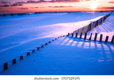 Winter Scene Under Color Sky At Sunset On Snow Covered Beach. Jones Beach State Park., Long Island NY