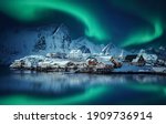 Winter scenery with aurora over Reine. Incredible winter view on snowcapped mountains, fishing village and Northern lights. Typical nature landscape of Lofoten islands. Norway. creative poscard 