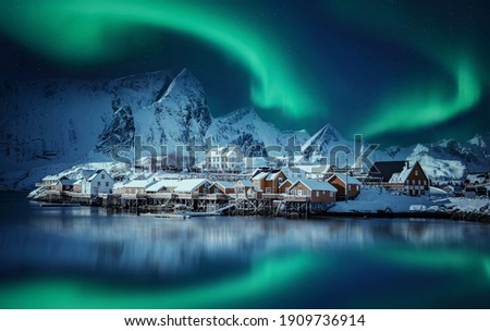 Winter scenery with aurora over Reine. Incredible winter view on snowcapped mountains, fishing village and Northern lights. Typical nature landscape of Lofoten islands. Norway. creative poscard  Stock photo © 