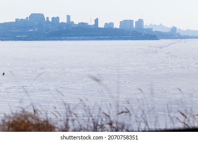 Winter Sea Fishing In Vladivostok. Frozen Amur Bay With Fishermen.