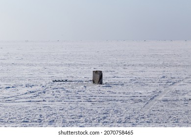 Winter Sea Fishing In Vladivostok. The Ice Fishing Box And Drill Are On The Sea Ice.