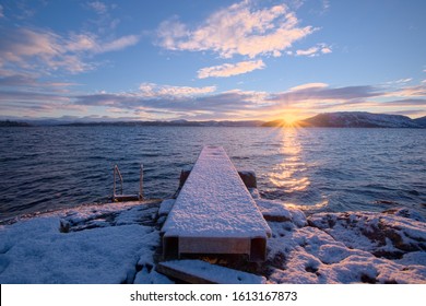 Winter Sea Swimming On A Snowy Day. Dawn Dips With Snow On The Diving Board. A Great Routine To Enjoy The Fresh Air And Wake Up With A Freezing Cold Dip.