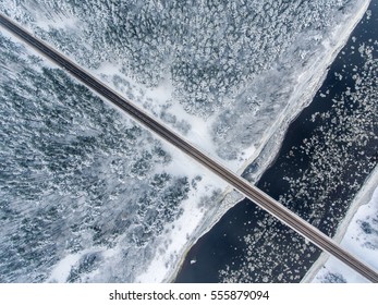 Winter Season Aerial Top Down View Of A Bridge With A Straight Line Road Over River Nemunas.