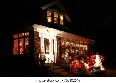 Winter Season House Outdoors Decoration. Night Scene With Porch And Front Yard Of The House Decorated By Glowing In The Dark Garlands. Christmas And New Year Holiday Background.