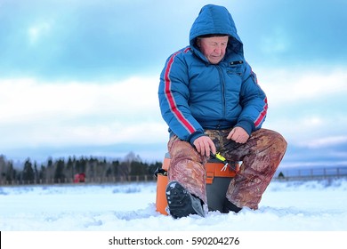 Winter Season Old Man Fishing On A Lake