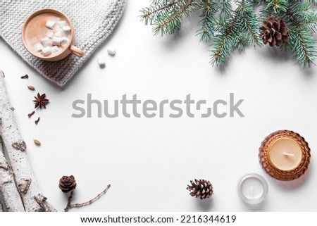 Winter seasonal concept. Christmas fir branches, pine cones, candles and hot coffee drink isolated on white background. Trendy flat lay, top view, copy space.