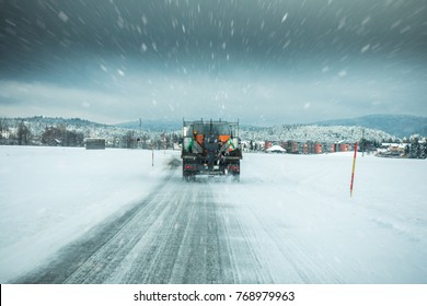 Winter Service Truck Or Gritter Spreading Salt On The Road Surface To Prevent Icing In Stormy Snow Winter Day. 