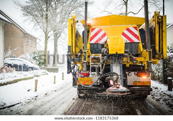 Winter service truck or spreading salt and\
sand on the road surface to prevent\
icing