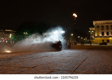 Winter Service Vehicle Clearing Thoroughfares Of Ice And Snow, Yellow Snow Plow Tractor Working On Empty Street At Night In Heavy Snowfall To Keep Roads Clear And Safe For Driving During Winter