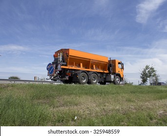 Winter Service Vehicle Or Gritter Spreading Rock Salt On The Road