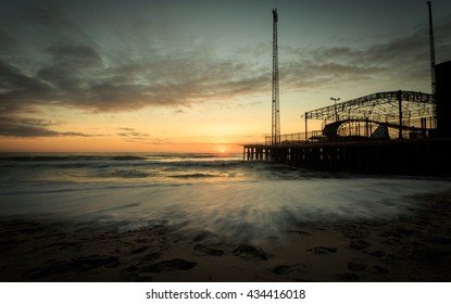 Winter Shot Of A New Jersey Shore Sunrise Over An Amusement Pier