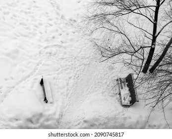 Winter in Siberia. The benches are covered with snow.