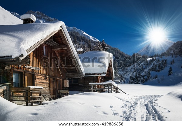 winter ski chalet and cabin in snow mountain \
landscape in tyrol\
austria