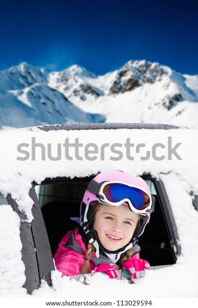 Winter, ski holiday - portrait of lovely skier in the\
snowy car