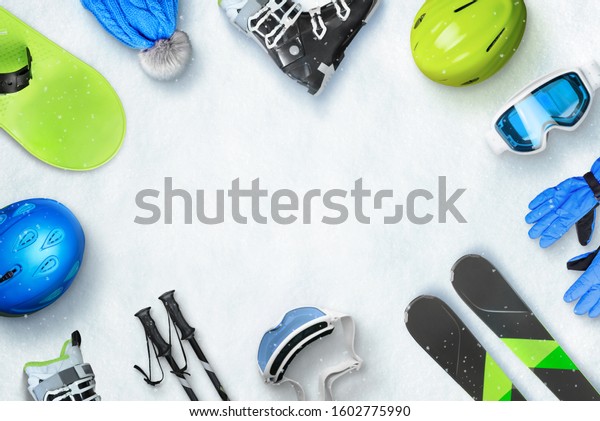 Winter ski sport accessories placed on\
snow with copy space in the middle for text or logo promotion. Top,\
view, flat, lay. Winter ski vacation\
concept