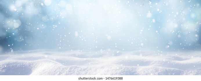 Winter snow background with snowdrifts, with beautiful light and snow flakes on the blue sky, beautiful bokeh circles, banner format, copy space. - Shutterstock ID 1476619388