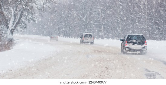Winter, snow, Blizzard, poor visibility on the road. Car during a Blizzard on the road with the headlights. - Shutterstock ID 1248440977