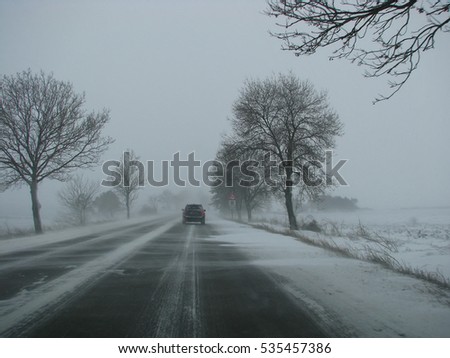 Winter, snow, Blizzard, poor visibility on the road. Car during a Blizzard on the road