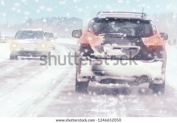 Winter, snow, Blizzard,\
poor visibility on the road. Car during a Blizzard on the road with\
the headlights.