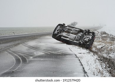 Winter Snow Condition Car Accident Concept, Car Lying On Its Roof After Hard Collision