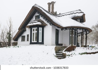 Winter Snow Covered Thatched Cottage In England