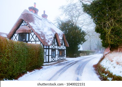 Winter Snow Covered Thatched Cottage In England