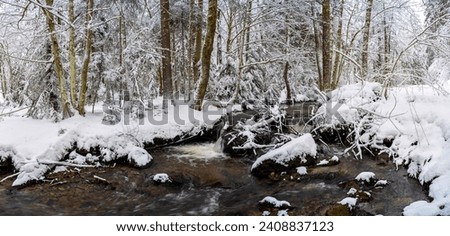 Winter snow forest river panorama. A river in a winter snow forest. Snow forest river flowing. River in winter snow forest