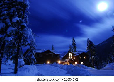 Winter Snow Scene Of A Cabin At Lake Kachess At Night With Moonlight.