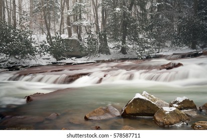 Winter snow shot of waterfall with blurred motion on Muddy Creek running into Cheat River off Route 26 in Preston County West Virginia