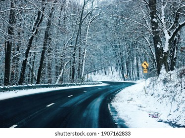 Winter Snow Storm On A Curvy Road With Snow Covered Trees Dark