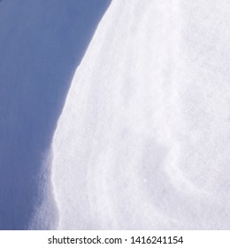 winter snow surface with patterns created by wind and other natural phenomena