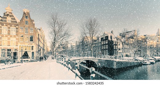 Winter snow view of Dutch canal and old houses in the historic city of Amsterdam - Powered by Shutterstock